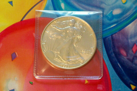 A 1993 silver eagle coin against birthday wrapping paper. photo by Joshua at TheFunTimesGuide.com A 1993 silver eagle coin against birthday wrapping paper.