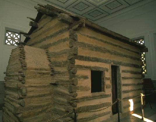 The original log cabin that Lincoln was born in as depicted on the first 2009 commemorative Lincoln penny. 