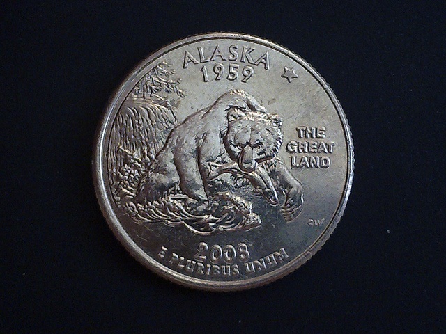 A Grizzly bear and fish adorn the Alaskan State quarter
