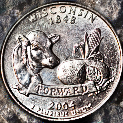 Wisconsin state quarter featuring a cow, a chees wheel and corn