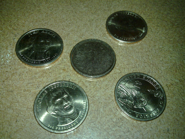A blank dollar coin next to several legit dollar coins. photo by diaper on Flickr I got ripped off. Blank dollar coin.
