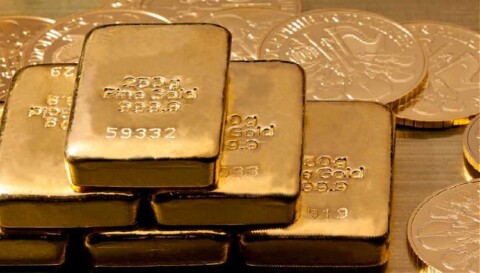 A picture of gold bars and gold coins. 