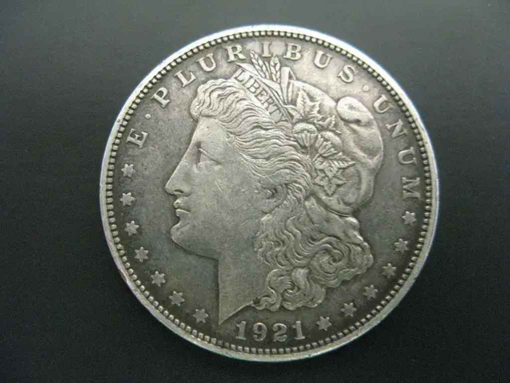 This 1921 Morgan dollar coin has a lower value than its 1921 Peace dollar counterpart. photo by frankieleon on Flickr 1921-dollar