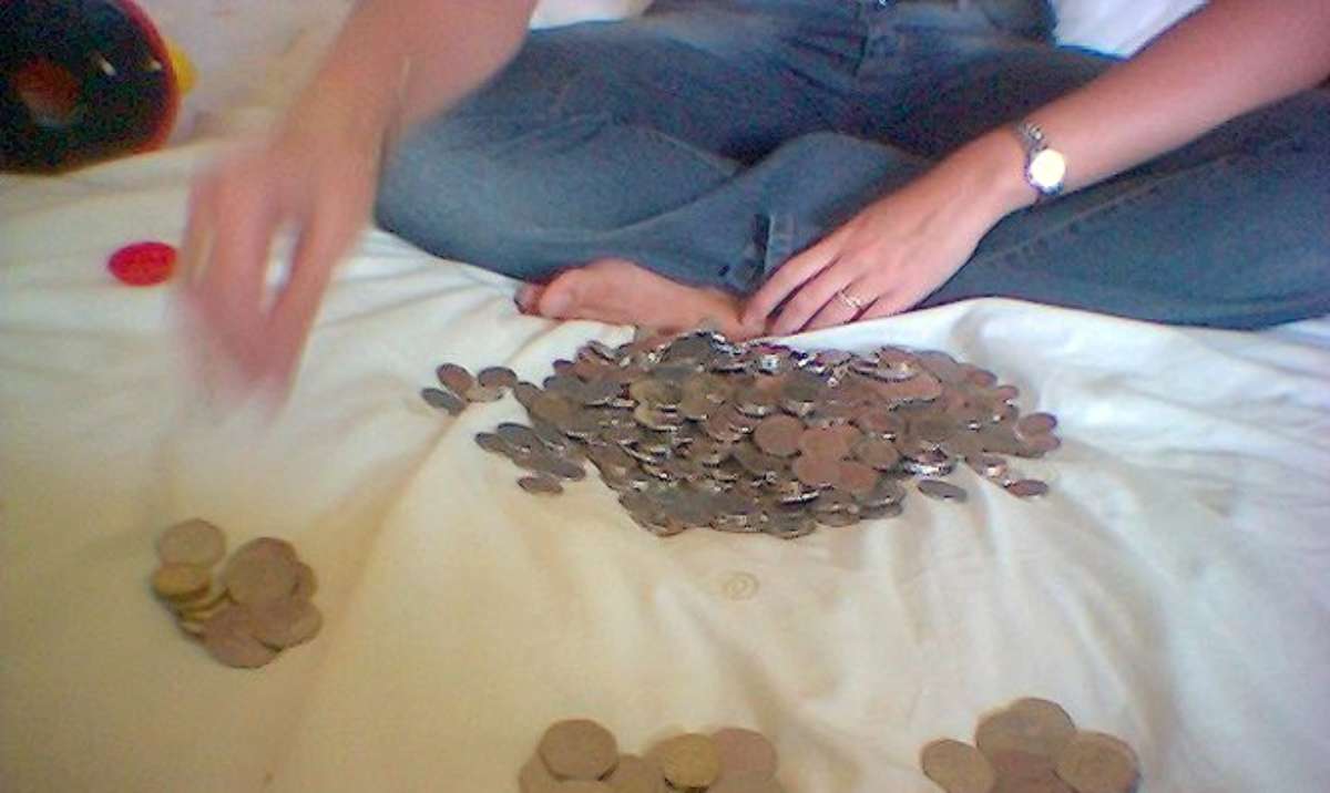 Sorting the coins from my spare change jar on the bed. Sorting the coins from my spare change jar on the bed.