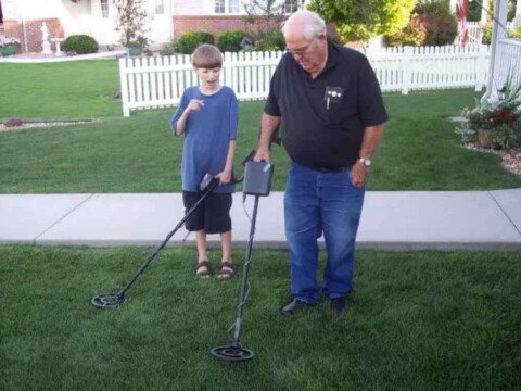 Grandpa and grandson are comparing their metal detectors and looking for old coins in the ground. photo by sscornelius on Flickr Grandpa and grandson are comparing their metal detectors and looking for old coins in the ground.