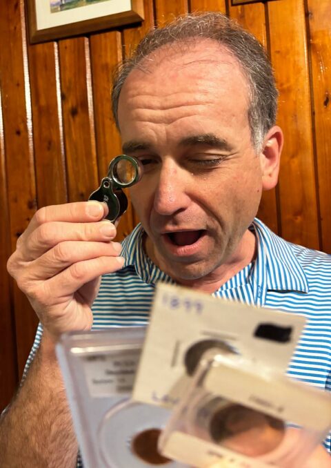 Here I'm inspecting some coins in holders. 